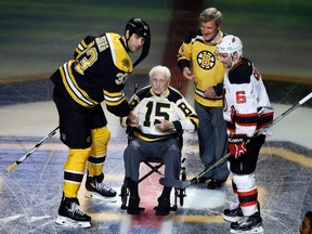 Bruins defenceman Zdeno Chara (33) and Devils defenceman Andy Greene (6) participate with Bruins legends Milt Schmidt (15) and Bobby Orr in a ceremonial puck drop before a game in Boston on Oct. 20, 2016. Schmidt has died at the age of 98, Bruins team spokesman Matt Chmura said Wednesday, Jan. 4, 2017. (Elise Amendola/AP Photo/Files)