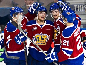 Edmonton Oil Kings' Aaron Irving (second from left) celebrates a goal with teammates. The 20-year-old captain was traded to the Everett Silvertips on Wednesday. (File)