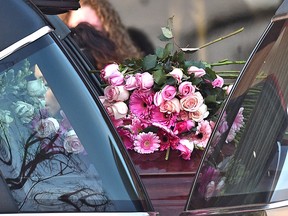 Flowers were placed by mourners at the end of Rachael Longridge's casket as it sits in the hearse outside of  St. Theresa's Catholic Parish at her funeral in Edmonton, Wednesday, January 4, 2017. Ed Kaiser/Postmedia