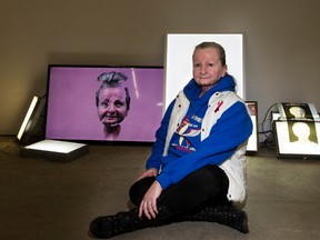 Cancer survivor Sharon Dixon poses for a photo with Edmonton artist Brad Necyk's mixed media piece titled Waiting Room, at dc3 Art Projects, 10567 - 111 St., in Edmonton on Wednesday, Jan. 4, 2017. David Bloom / Postmedia