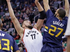 Toronto Raptors centre Jonas Valanciunas (17) shoots as Utah Jazz centre Rudy Gobert (27) defends in the first half during an NBA basketball game  Dec. 23, 2016, in Salt Lake City. (RICK BOWMER/AP)