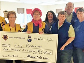 Minnow Lake Lions donated $1,500 to the Holy Redeemer Food Bank. Keith Argent, left, Leanne Furchner, Shirley Ogilvy, Monique Macintyre, Berie and Brian van Vlymen and Julie Lackmanec were on hand for the donation. Supplied photo