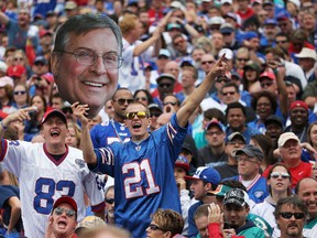 A Buffalo Bills fan holds up a picture of Terry Pegula during the first half against the Miami Dolphins at Ralph Wilson Stadium on Sept. 14, 2014. (Tom Szczerbowski/Getty Images)