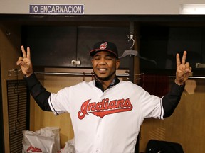 New Cleveland Indian Edwin Encarnacion smiles wearing an Indians baseball jersey on Jan. 5, 2017. (AP Photo/Tony Dejak)