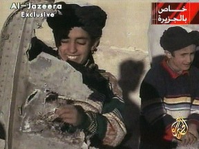 In this image made from video broadcast by the Qatari-based satellite television station Al-Jazeera Wednesday, Nov. 7, 2001, a young boy, left, identified as Hamza bin Laden holds what the Taliban says is a piece of U.S. helicopter wreckage in Ghazni, Afghanistan on Monday, Nov. 5, 2001. The Obama administration has announced terrorism-related sanctions against a son of Sept. 11 mastermind Osama bin Laden. The State Department says Hamza bin Laden has been “determined to have committed, or pose a serious risk of committing, acts of terrorism that threaten the security of U.S. nationals or the national security.” (AP Photo/Al-Jazeera via APTN)