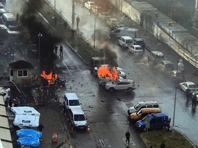 Cars burn after a car bomb explosion in Izmir, Turkey, Thursday, Jan. 5, 2017. An explosion believed to have been caused by a car bomb in front of a courthouse in the western Turkish city of Izmir on Thursday wounded several people, a local official said. Two of the suspected attackers were killed in an ensuing shootout with police. (DHA-Depo Photos via AP)