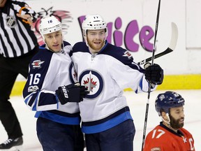 Winnipeg Jets centre Shawn Matthias (16) is congratulated by teammate Adam Lowry (17) after Matthias scored against the Florida Panthers. (AP Photo/Alan Diaz)