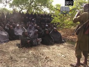 This Monday, May 12, 2014, file image taken from video by Nigeria's Boko Haram terrorist network, shows the alleged missing girls abducted from the northeastern town of Chibok. Soldiers interrogating captured Boko Haram suspects have found one of the Chibok schoolgirls kidnapped by the extremist group nearly three years ago, along with her baby, Nigeria's military said Thursday Jan. 5, 2017. (AP Photo/File)
