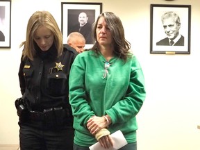 Michelle Lodzinski is escorted from the courtroom after being sentenced to 30 years for the 1991 murder of her 5 year-old son Timothy Wiltsey, Thursday, Jan. 5, 2017, at Middlesex County Court in New Brunswick, N.J. (Patti Sapone/NJ Advance Media via AP, Pool)