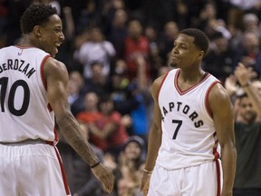 Toronto Raptors guard DeMar DeRozan celebrates Toronto Raptors guard Kyle Lowry three pointer to put a dagger in Utah Jazz in Toronto, Ont. on Thursday January 5, 2017. (Craig Robertson/Toronto Sun/Postmedia Network)