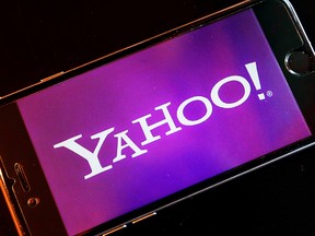 In this Dec. 15, 2016, file photo, the logo of Yahoo appears on a smartphone in Frankfurt, Germany. (AP Photo/Michael Probst, File)