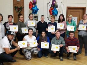 Graduates from Bridges Out of Poverty's Getting Ahead Program proudly show off their certificates of completion. The guided YWCA-affiliated initiative gives low income individuals an opportunity to reflect on their situation, identify goals and opportunities in their lives and pull themselves out of poverty. The nine-week Getting Ahead Program is starting up again on Jan. 25.