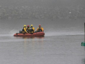 A boat carrying a recovery team rides on the shoreline of Lake Erie, Tuesday, Jan. 3, 2017, in Cleveland. (AP Photo/Tony Dejak)