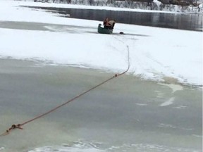 Officers rescuing Louis the puppy from the icy Gatineau River.