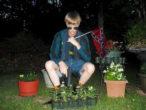 This undated photo that appeared on Lastrhodesian.com, a website investigated by the FBI in connection with Dylann Roof, shows him posing for a photo holding a Confederate flag. During Dylan Roof's sentencing for friends and family members walked up to the witness stand and testified about the nine black church members gunned down during a Bible study. The testimony came during the sentencing phase of Dylann Roof's death penalty trial. (Lastrhodesian.com via AP, File)