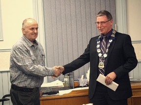 Paul Josling, former inspector for the municipality of Huron East shakes hands with the Mayor of Huron East, Bernie MacLellan. Josling, Connie Marion and Barry Mills, public works manager for Huron East were recognized for their contributions as municipal employees.(Shaun Gregory/Huron Expositor)