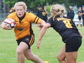 Addy Walker of the Trenton Tigers carries the ball against an Uxbridge defender during a Barbarian Cup junior girls rugby match last year at MAS Park. (Barbarian Cup photo)