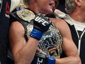 Holly Holm holds the champion belt after defeating Ronda Rousey during their UFC 193 bantamweight title fight in Melbourne, Australia, Sunday, Nov. 15, 2015. Holm pulled off a stunning upset victory over Rousey in the fight, knocking out the women's bantamweight champion in the second round with a powerful kick to the head Sunday. (AP Photo/Andy Brownbill)  Holly Holm