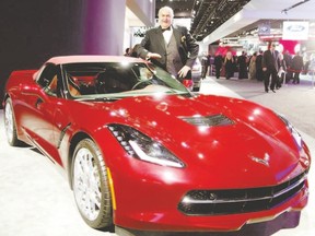 Writer Jim Fox sizes up a red Corvette convertible at the Detroit auto show gala. (Special to Postmedia News)