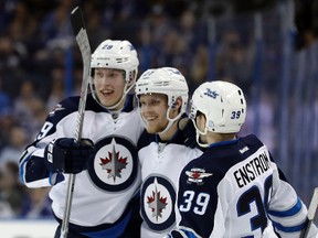 Nikolaj Ehlers (27) celebrates his goal against the Tampa Bay Lightning with teammates Patrik Laine and defenseman Toby Enstrom during Tuesday night's win in Tampa. (AP Photo/Chris O'Meara)