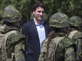 Canadian Prime Minister Justin Trudeau reviews an honour guard as they arrive at the International Peacekeeping and Security Centre in Yavoriv, Ukraine Tuesday July 12, 2016. (THE CANADIAN PRESS/Adrian Wyld)