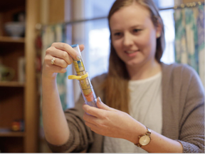 Kate Henderson, who has a peanut allergy, handles her EpiPen in her Ottawa home on Jan. 6, 2017. (David Kawai, Postmedia)