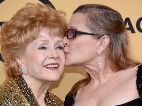 Actresses Debbie Reynolds (L), recipient of the Screen Actors Guild Life Achievement Award, and Carrie Fisher pose in the press room at the 21st Annual Screen Actors Guild Awards at The Shrine Auditorium on January 25, 2015 in Los Angeles, California. (Ethan Miller/Getty Images)