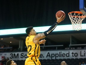 Julian Boyd of the Lightning goes way up for a finger roll over Josiah More and Kirk Williams Jr. of the Niagara River Lions during their Thursday January 5, 2017 game at Budweiser Gardens in London, Ont. (MIKE HENSEN, The London Free Press)