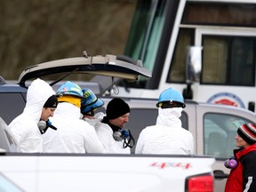 In this Wednesday, Jan. 4, 2017, photo, emergency personnel investigate the scene after a fire damaged three structures on a property in rural Hubbard, Ore. The Marion County Sheriff's Office said Thursday that detectives confirm the remains are of a man, a woman and three children. They were found over the last two days in the smoldering debris, and the bodies appear consistent with that of a family which owns the property, the sheriff's office said. (Anna Reed/Statesman-Journal via AP)