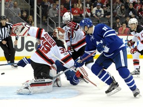 Maple Leafs' Auston Matthews (rear) scores a goal behind Devils goaltender Cory Schneider as Leafs' Zach Hyman (right) looks on during first period NHL action in Newark, N.J., on Friday, Jan. 6, 2017. (Bill Kostroun/AP Photo)