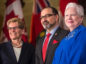 Ontario Premier Kathleen Wynne and Lt.-Gov. Elizabeth Dowdeswell pose for a photo with Glenn Thibeault (centre), Minister of Energy after his swearing-in at Queen's Park in Toronto on Monday, June 13, 2016. THE CANADIAN PRESS/Eduardo Lima