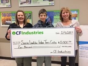 Petrolia teen Matt Mueller accepts a $5,000 cheque from Natasha Berdan, left, and Dorothy Ewener, of CF Industries. Mueller accepted the donation on behalf of the group working to establish an indoor tennis complex in Sarnia. Handout/Sarnia Observer/Postmedia Network