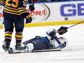 Patrik Laine of the Winnipeg Jets is knocked out after a check by Jake McCabe of the Buffalo Sabres during the third period at the KeyBank Center on January 7, 2017 in Buffalo, New York. The Sabres beat the Jets 4-3. (Photo by Kevin Hoffman/Getty Images)