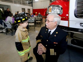 Devlin Davey, 5, of Tyendinaga Township gives Belleville Deputy Fire Chief Bruce Greatrix his thoughts on firefighting after the opening ceremony of Belleville's new Station 5 Saturday, January 7, 2017 in Plainfield, Ont. Unlike the other two Belleville stations opened in the last 18 months, it's a new location, not a replacement.