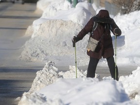 A woman slowly makes her way along a snow covered sidewalk in Winnipeg's North End. Saturday, January 07, 2017. (Winnipeg Sun/Postmedia Network)