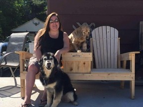 Denise Ramsay poses with her 12-year-old dog, a German shepherd golden retriever mix named Sadie, and 11-year-old dog, a cocker spaniel named Samie, in this undated handout photo. A New Brunswick woman says she is distraught and heartbroken after receiving a ransom call for her missing dog. Ramsay says her 12-year-old German shepherd Labrador mix dog vanished from her yard in Miramichi at about 10 p.m. on Dec. 28. (THE CANADIAN PRESS/HO - Denis Ramsay)