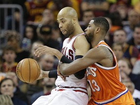 Bulls' Taj Gibson (left) drives against Cavaliers' Tristan Thompson in the first half of an NBA game in Cleveland on Wednesday, Jan. 4, 2017. (Tony Dejak/AP Photo)