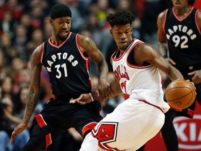 Bulls guard/forward Jimmy Butler (right) controls the ball against Raptors forward/guard Terrence Ross (left) during first half NBA action in Chicago on Saturday, Jan. 7, 2017. (Nam Y. Huh/AP Photo)
