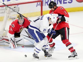 Senators defenceman Marc Methot (right) battles with Maple Leafs forward Zach Hyman (centre) while goalie Craig Anderson (left) keeps his eye on the puck during second period NHL action at the Canadian Tire Centre in Ottawa on Oct. 12, 2016. (Wayne Cuddington/Postmedia)