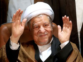 In this Dec. 21, 2015 file photo, former Iranian President Akbar Hashemi Rafsanjani waves to journalists as he registers his candidacy for the elections of the Experts Assembly, in Tehran, Iran. (AP Photo/Ebrahim Noroozi, File)
