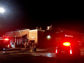 Kingston firefighters investigate a fire at Boston Pizza on Dalton Avenue in Kingston, Ont. on Saturday, Jan. 7, 2017. The fire was in the restaurant's main electrical room. No injuries were reported and the cause of the fire is being investigated. Damage is estimated at $15,000.