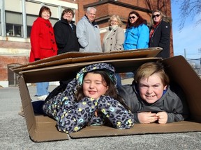 Luke Hendry/The Intelligencer
Addison Moyles, 8, and and Nate Campbell, 9, join Canadian Mental Health Association staff Saturday, outside the association's office in Belleville to promote Sleep Out So Others Can Sleep in. In the background from left are Wendy Danford, Alex French, Scott Henderson, Sandie Sidsworth, Caitlin Moyles and Jaime Campbell. The outdoor fundraiser for transitional homes returns Jan. 27.