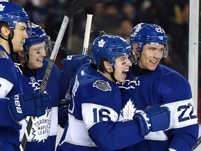 Toronto Maple Leafs centre Mitch Marner celebrates his goal with teammates James van Riemsdyk, Tyler Bozak and Nikita Zaitsev during third period NHL Centennial Classic hockey action against the Detroit Red Wings, in Toronto on Sunday, January 1, 2017. (THE CANADIAN PRESS/Frank Gunn)