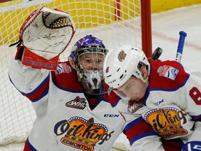 Edmonton Oil Kings goalie Patrick Dea keeps his eye on the puck as it bounces off teammate Ethan Cap on the way to a 5-2 loss to the Medicine Hat Tigers in Edmonton on Sunday, Jan. 8, 2016. (Larry Wong)