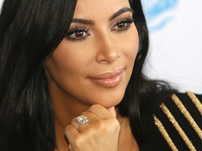 In this June 24, 2015 file photo, American TV personality Kim Kardashian attends the Cannes Lions 2015, International Advertising Festival in Cannes, southern France. Paris police Monday Jan.9, 2017 say 16 people have been arrested over Kim Kardashian jewelry heist. (AP Photo/Lionel Cironneau, File)
