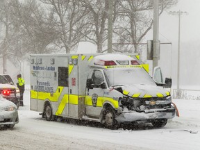 A Middlesex-London ambulance shows front end damage after a collision on Adelaide Street at Windermere Road Sunday. (MIKE HENSEN, The London Free Press)