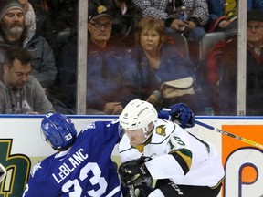 Mississauga Steelheads defenseman Stefan LeBlanc collides face-first into the boards while chasing after a loose puck with London Knights forward Cole Tymkin during their OHL game in London, Ont. on Friday December 9, 2016. (Free Press file photo)