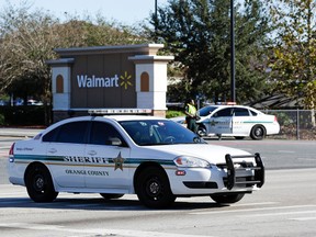Orange County Sheriff’s officers block the entrance to a Walmart near the scene where a police officer was shot, Monday, Jan. 9, 2017, in Orlando, Fla. (AP Photo/John Raoux)