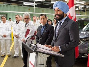 Navdeep Bains (right), minister of innovation, science and economic development, together with Ontario OECD Minister Brad Duguid (left) and Honda Canada president Jerry Chenkin (far left) make a funding announcement at the Honda manufacturing plant in Alliston, Ont., on Monday Jan. 9, 2017. THE CANADIAN PRESS/Frank Gunn
