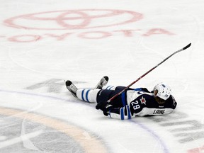 Winnipeg Jets forward Patrik Laine lays on the ice after being hit during the third period of Saturday's game in Buffalo. (AP Photo/Jeffrey T. Barnes)